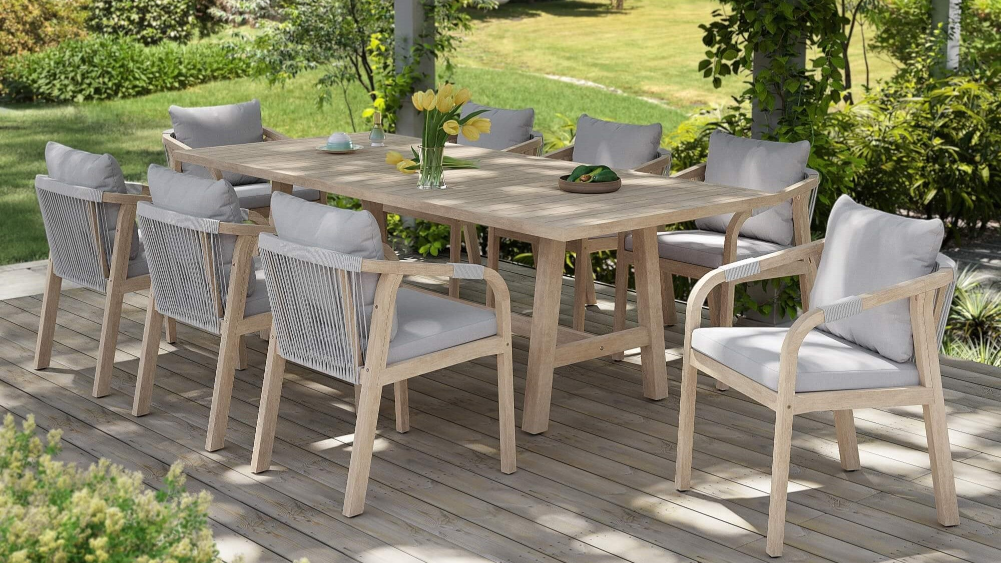 Outdoor dining set with a table and chairs on a wooden deck.