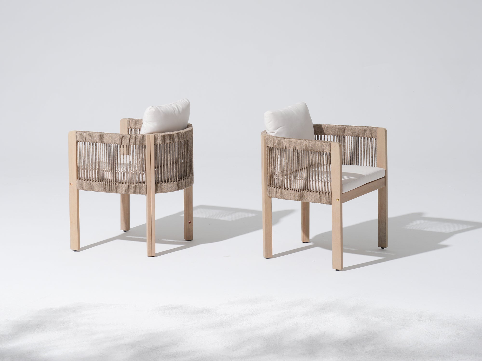 Two wooden chairs with woven rope backrests and white cushions, side angles- Jardina Modern Premium Outdoor Patio Furniture