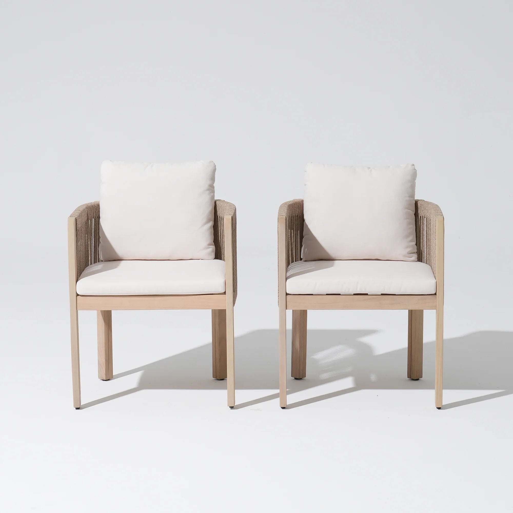Two acacia wooden dining chairs with white cushions, front angle - Jardina Modern Premium Outdoor Patio Furniture Sets