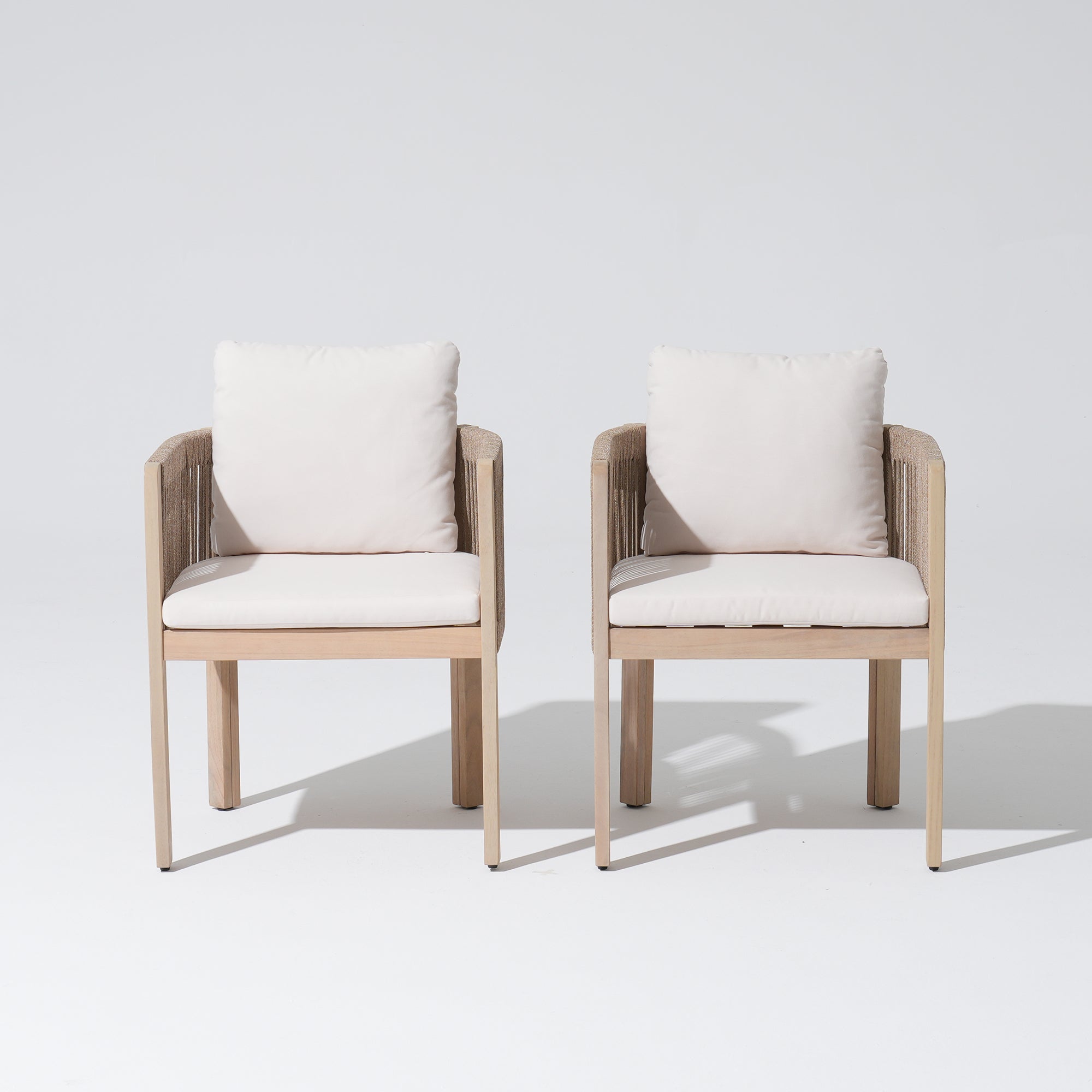 Two acacia wooden dining chairs with white cushions, front angle - Jardina Modern Premium Outdoor Patio Furniture Sets