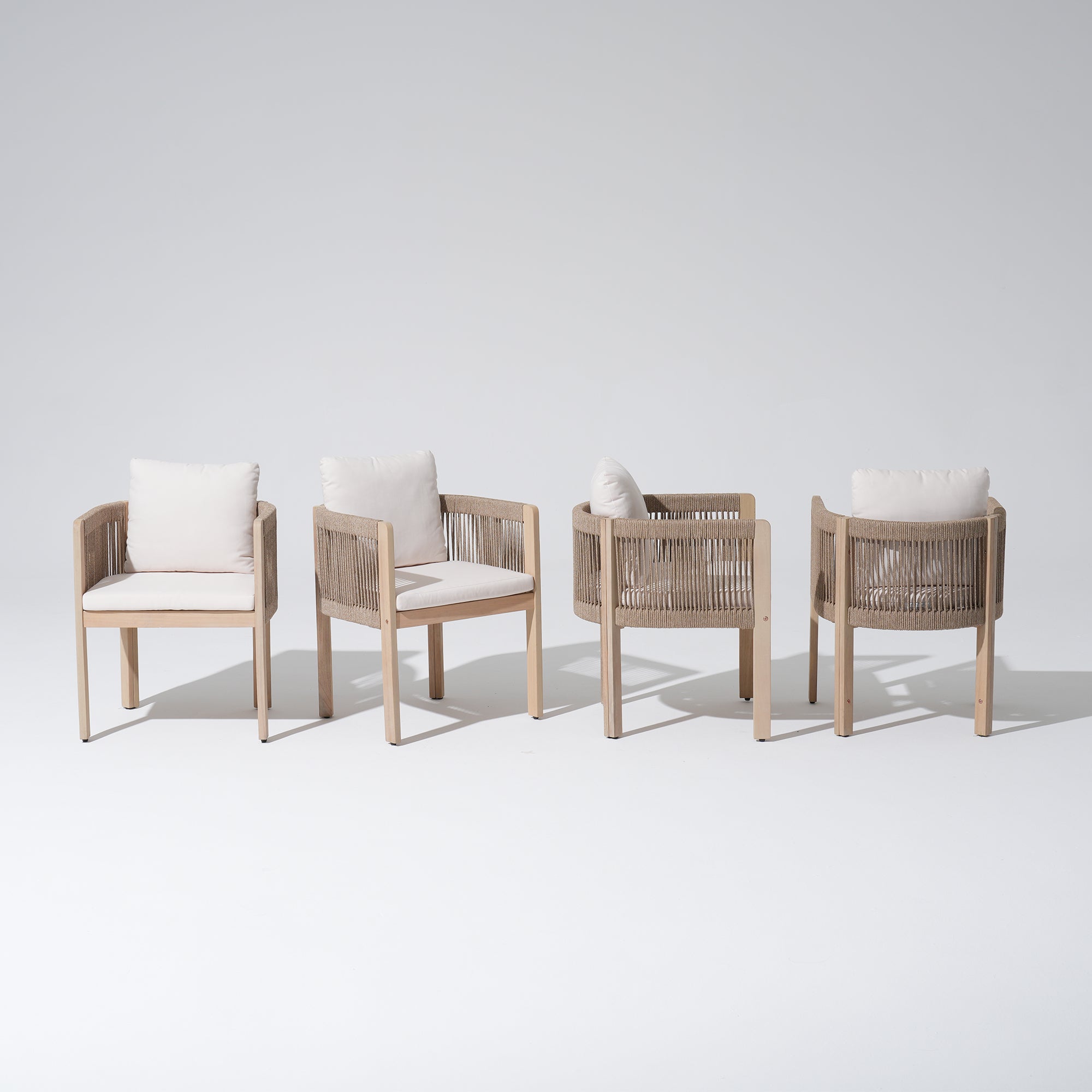 Four wooden patio dining chairs with woven armrests and white cushions- Jardina Modern Premium Outdoor Patio Furniture