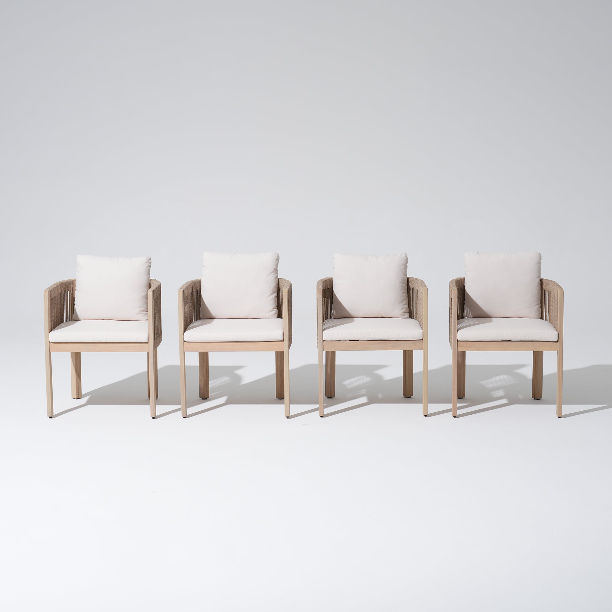 Four wooden dining chairs with white cushions, front angle- Jardina Modern Premium Outdoor Patio Furniture