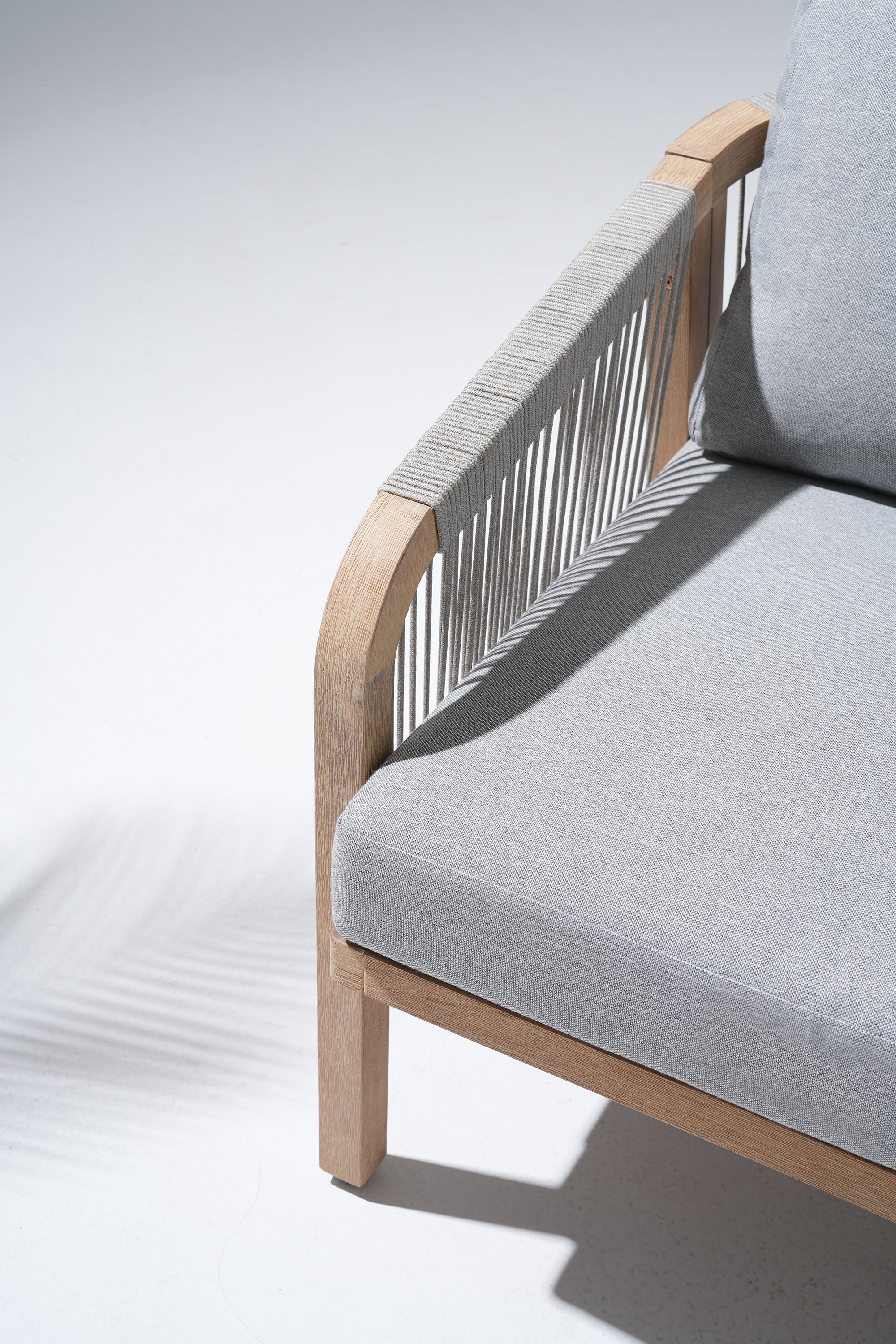 Gray cushioned chair with wooden frame