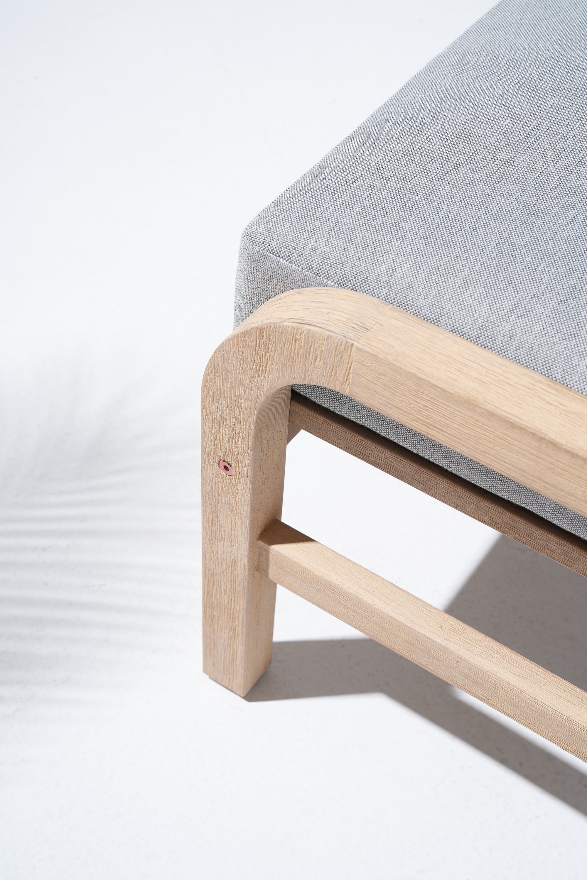 Gray cushioned chair with wooden frame