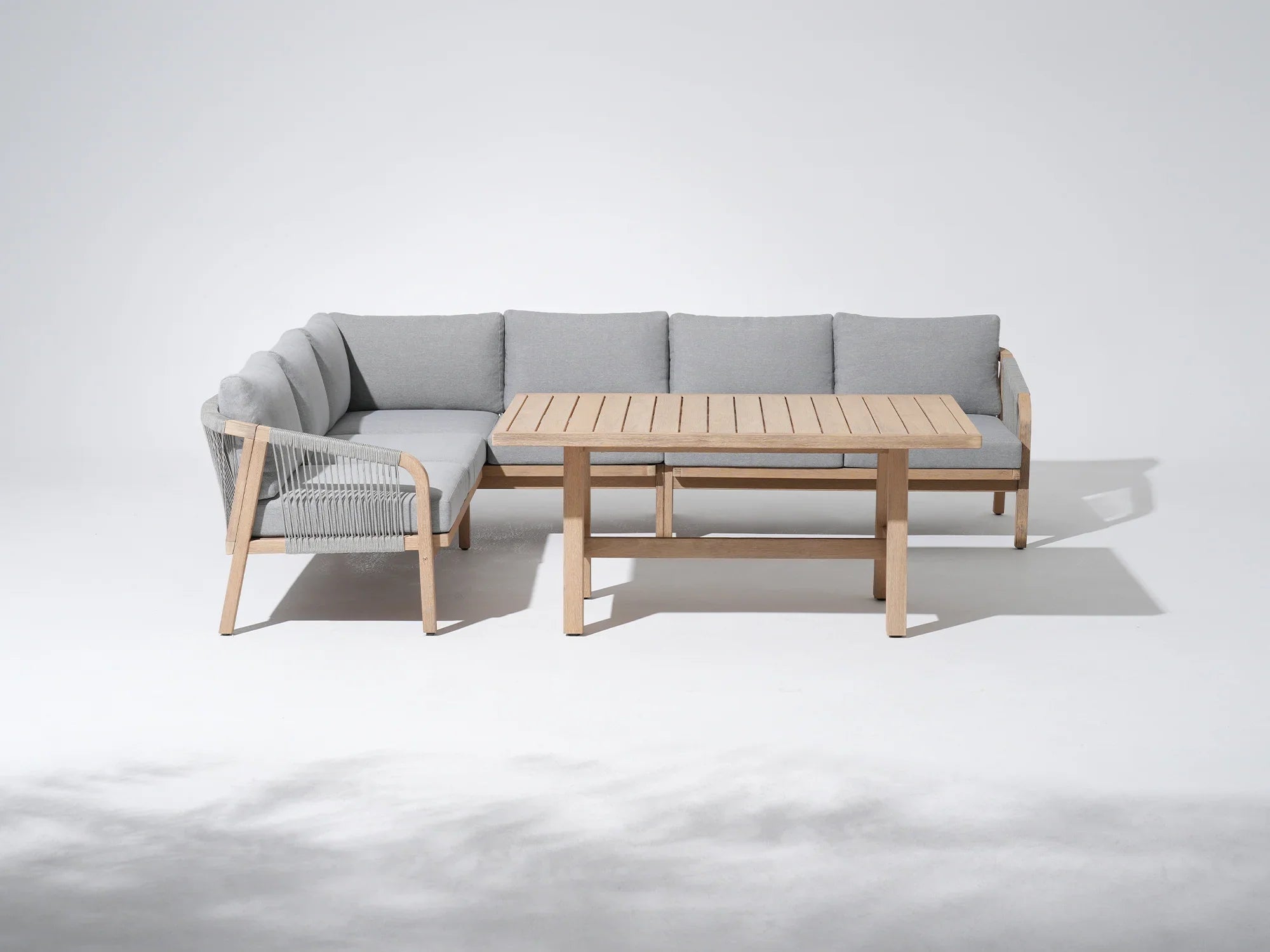 Outdoor furniture conversation set with a L-shaped sectional sofa and wooden dining table