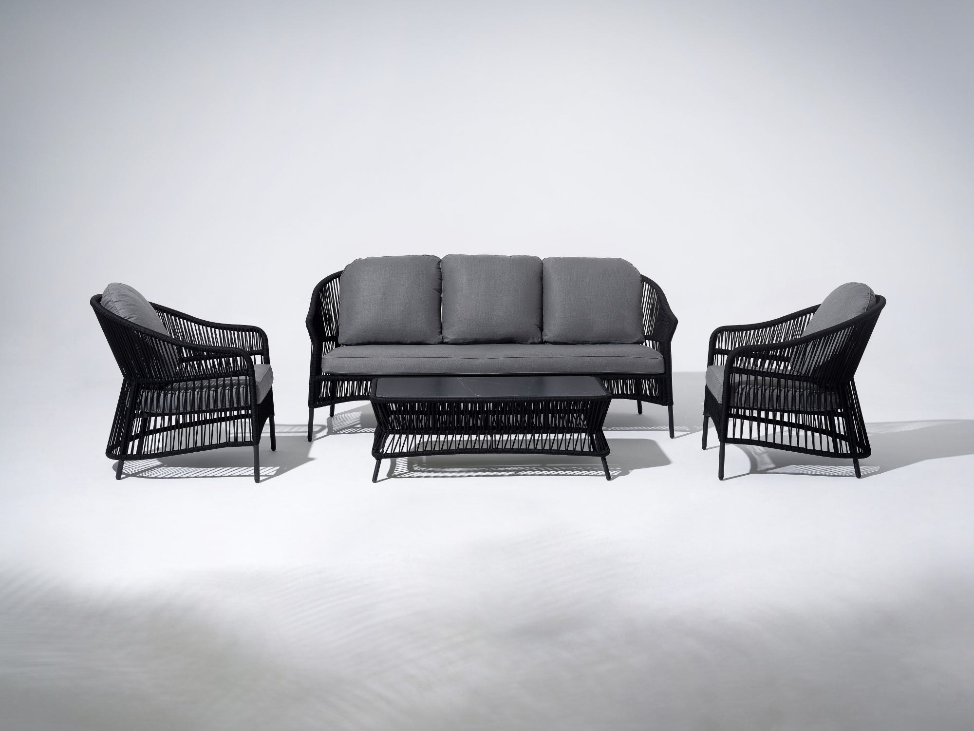 4-pcs Outdoor seating conversation set with gray seat cushions and back cushions, a 3-seat sofa, two single sofa armchairs with black rope design, a rectangular outdoor coffee table with black rope design and Sintered Stone Top Table - Jardina Premium Modern Outdoor Patio Furniture Set