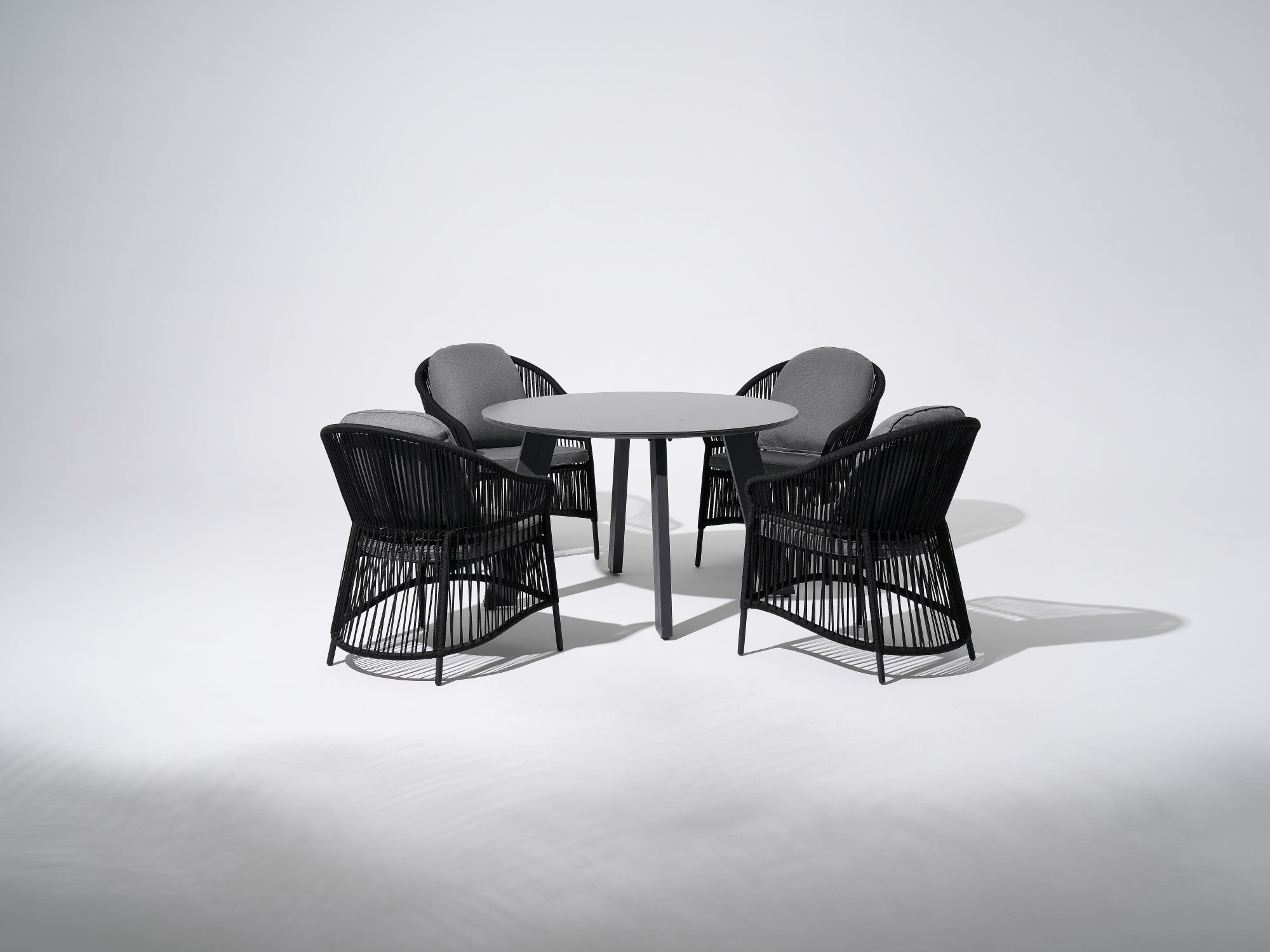 Aluminum Outdoor Dining Set For 4,  grey aluminum round dining table and four dining chairs with black rope design and gray cushions - Jardina Premium Modern Outdoor Patio Dining Furniture Set