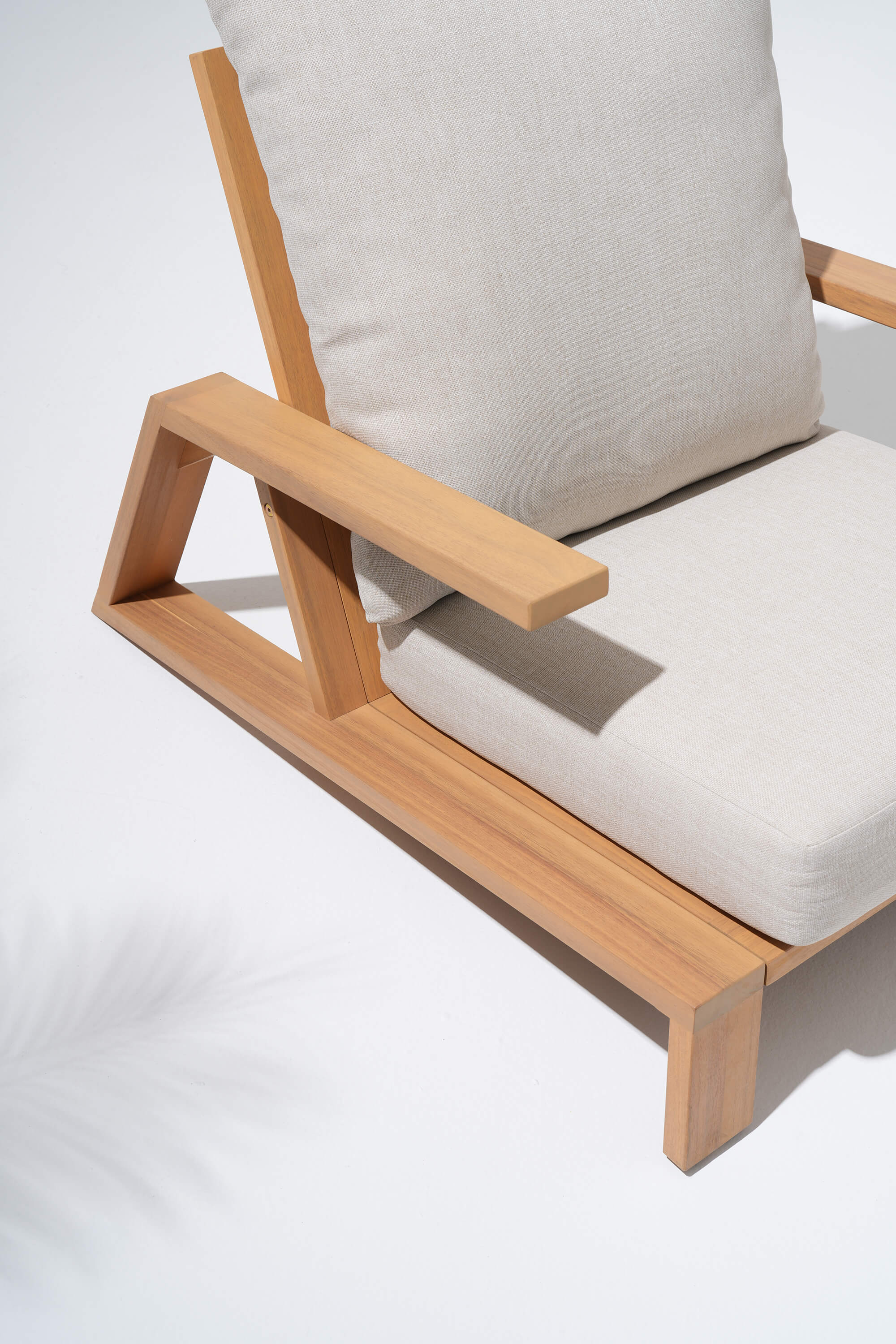 Wooden chair with gray cushions armrest detail