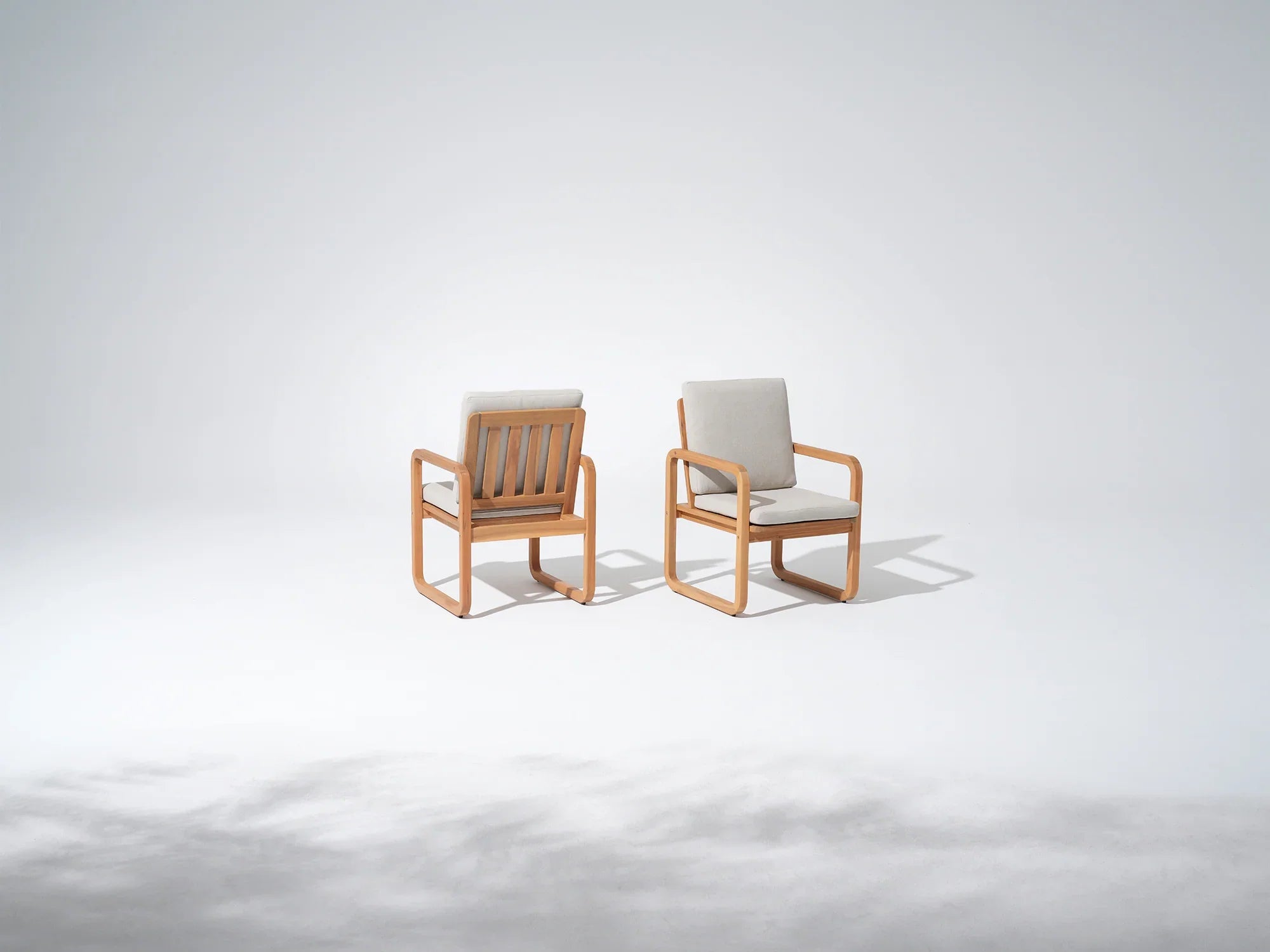 Two acacia wooden chairs with white cushions - Jardina Premium Modern Outdoor Dining Furniture