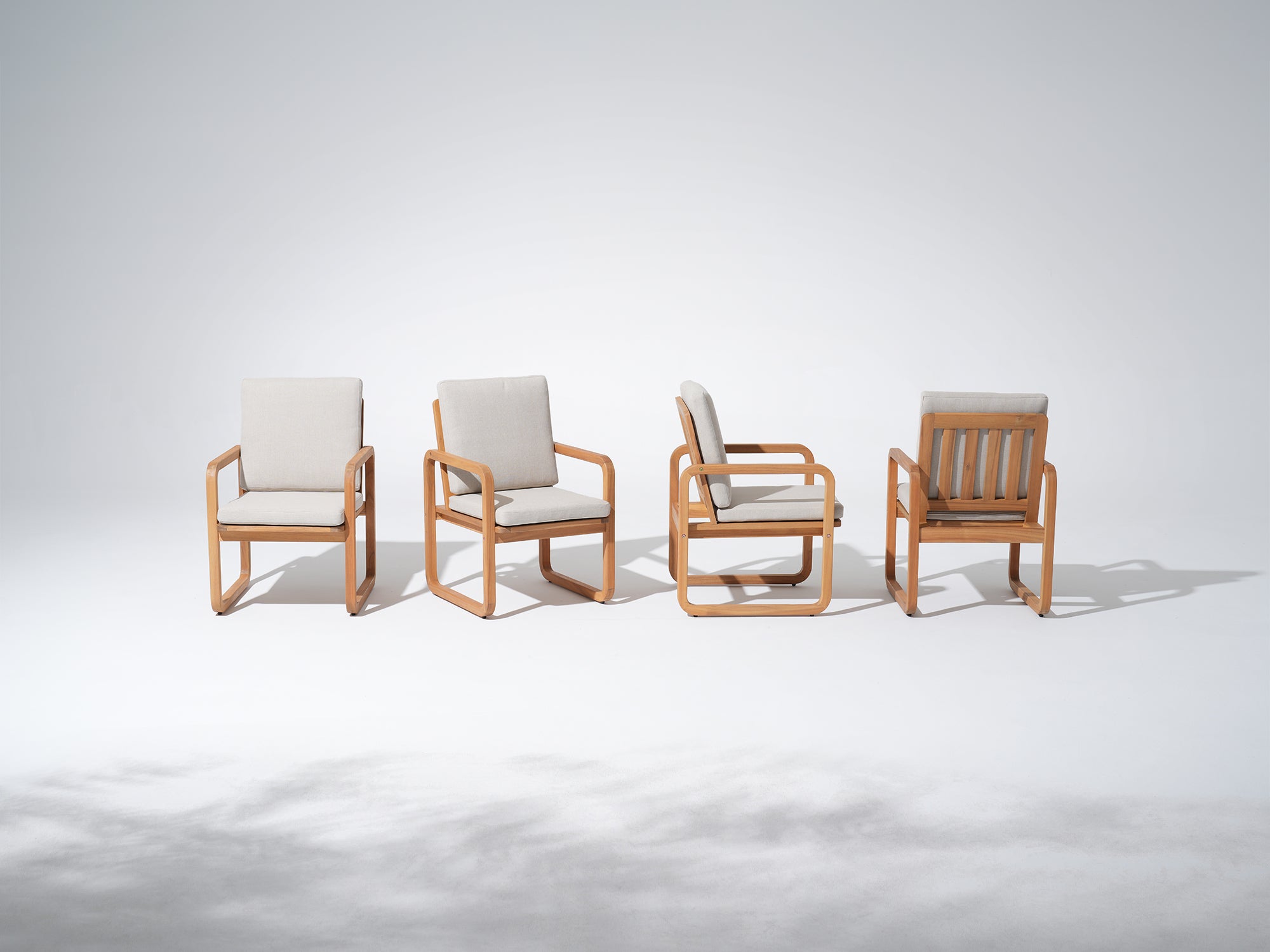 Four acacia wooden dining chairs with beige cushions - Jardina Premium Modern Outdoor Dining Furniture