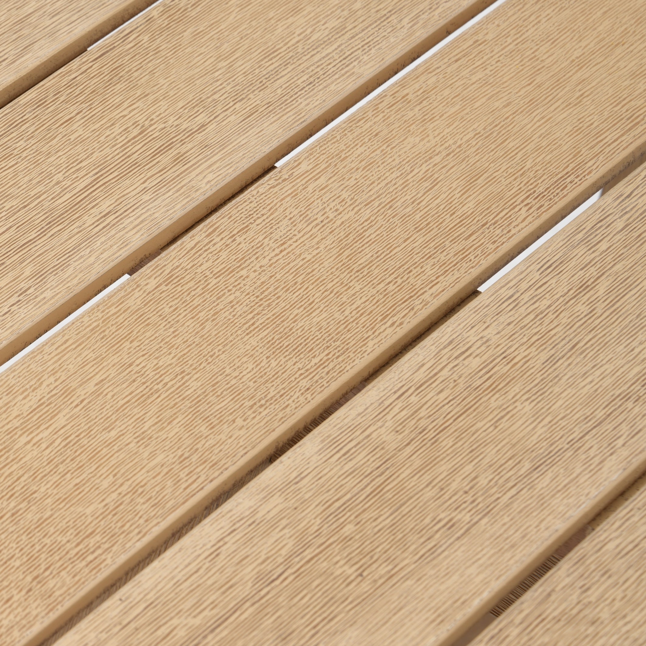 Close-up of acacia wooden deck tiles with a slat pattern
