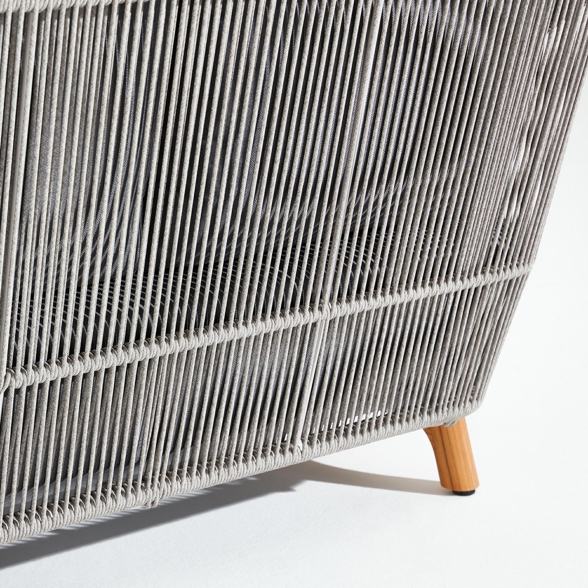 Close-up of a woven rope sofa with teak wooden legs -Jardina