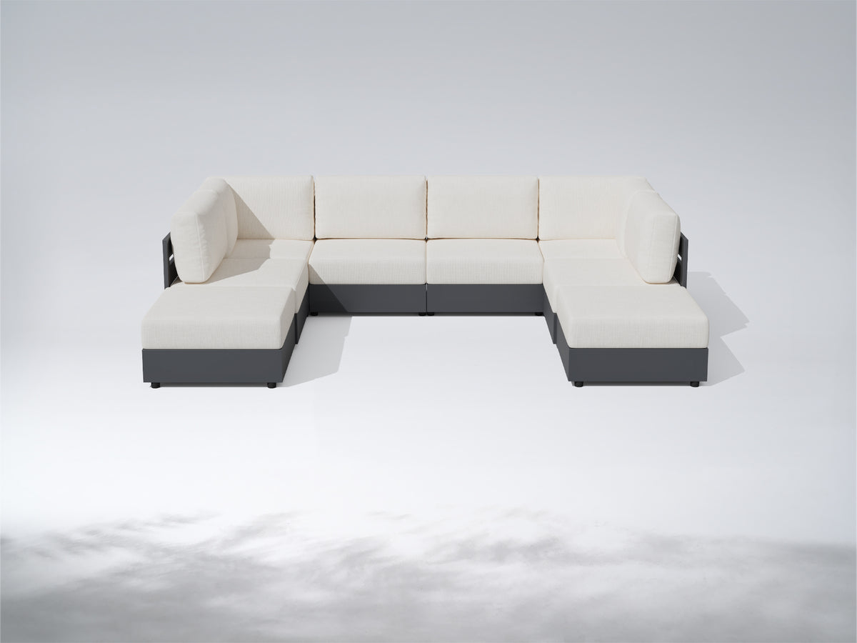 A modern sectional sofa with cream-colored cushions and a dark gray frame, shown on a light gray studio background. #config_U‑Shape with Ottomans