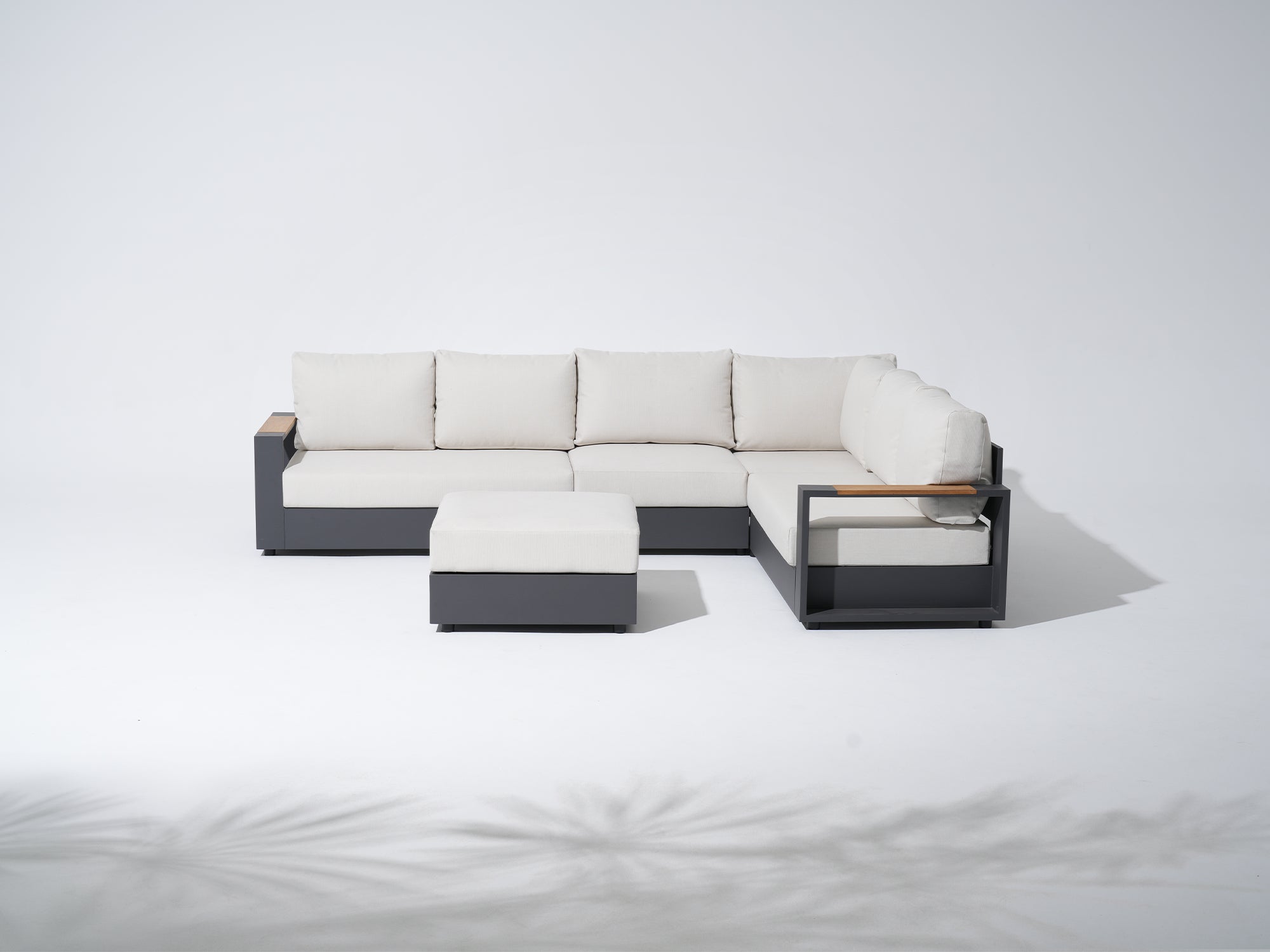 Modern outdoor sofa set with white cushions and dark grey aluminum frames