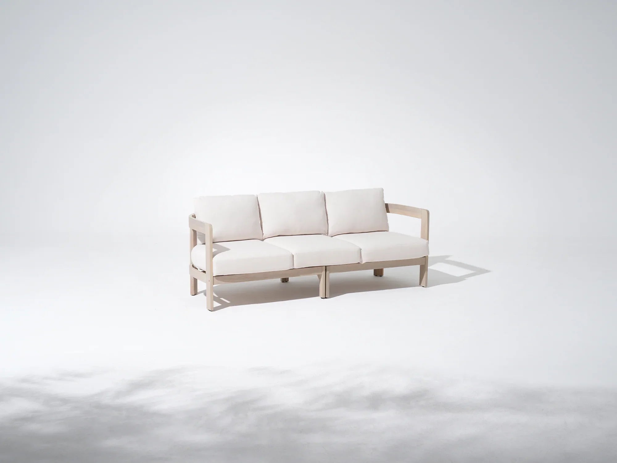 Minimalist natural acacia wood outdoor couch with curved armrest and white cushions - Jardina Modern Premium Outdoor Patio Furniture