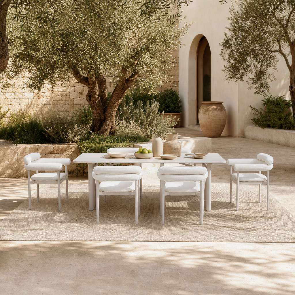 An outdoor dining set consisting of a rectangular white table and six matching armchairs with white cushions- Jardina premium modern outdoor patio furniture