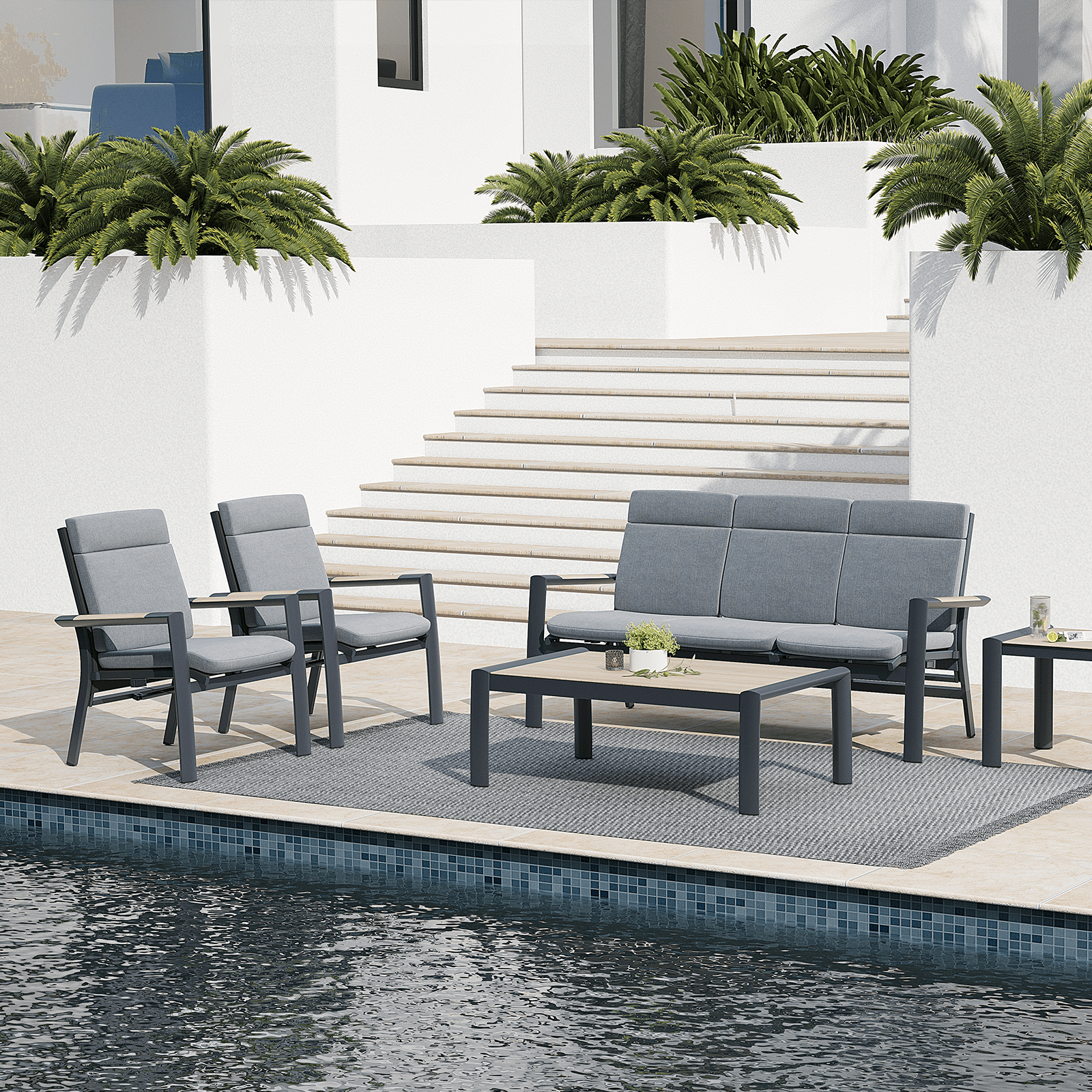Capri 5-Piece grey aluminum outdoor conversation set with grey cushions, 1 three-seater sofa with adjustable backrest, 2 armchairs with adjustable backrest, 1 rectangle coffee table, 1 square side table, beside a pool- Jardina Furniture